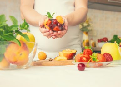 a pregnant woman eats fruit selective focus 2022 06 17 02 57 25 utc