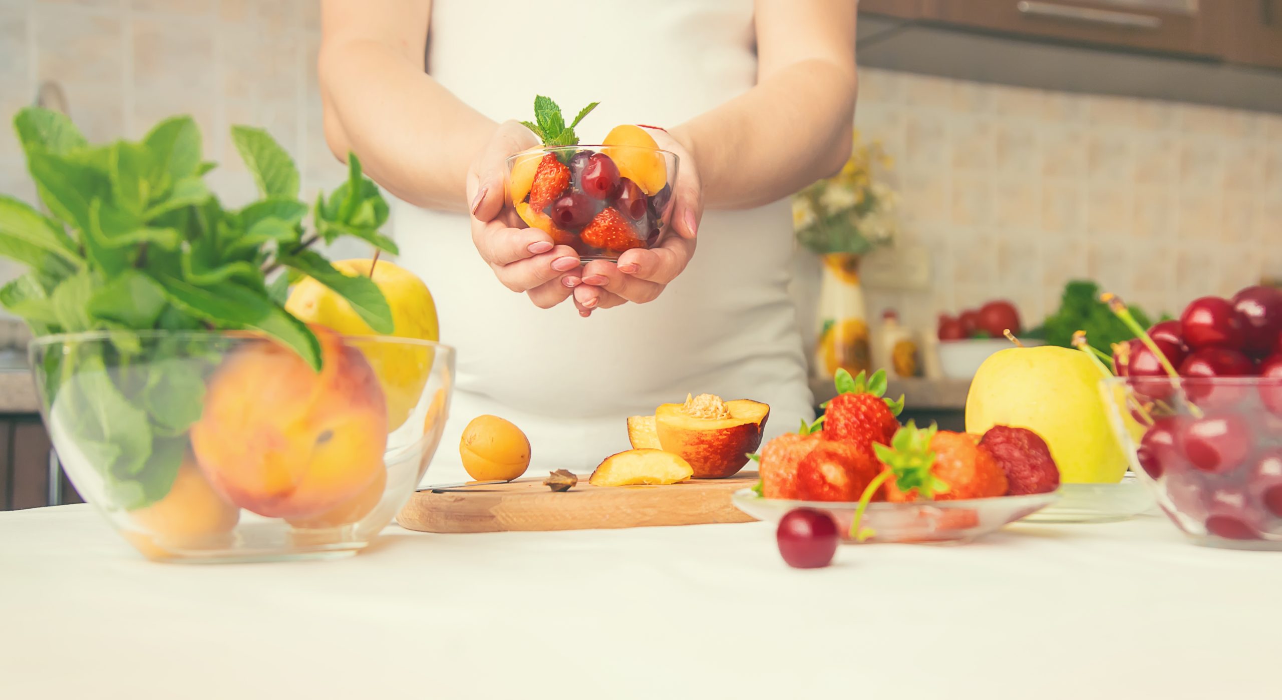 a pregnant woman eats fruit selective focus 2022 06 17 02 57 25 utc scaled